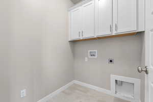 Laundry room with washer hookup, hookup for an electric dryer, and cabinets