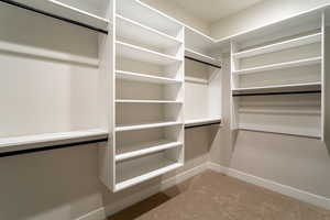 Spacious closet featuring carpet flooring