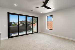 Spare room with a textured ceiling, light carpet, and ceiling fan