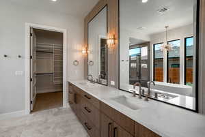 Bathroom featuring a chandelier and vanity