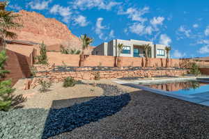 View of yard featuring a fenced in pool and a mountain view