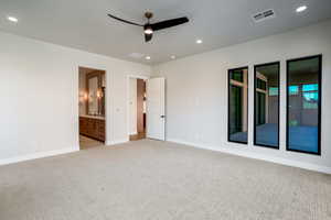 Unfurnished bedroom with sink, ensuite bathroom, and light colored carpet