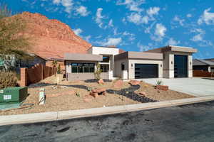 Contemporary home with a mountain view and a garage