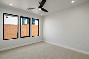 Carpeted empty room with ceiling fan