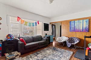 Living room with dark wood-type flooring