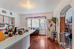 Kitchen with dark wood-type flooring and white fridge