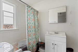 Bathroom with vanity and shower / bathtub combination with curtain