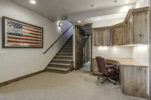 Home office featuring light carpet