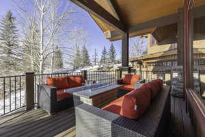 Snow covered deck featuring outdoor lounge area