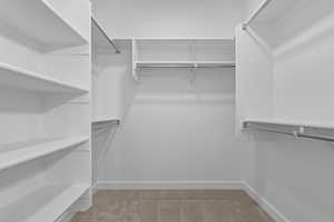 Spacious closet with light colored carpet