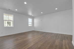 Unfurnished room with wood-type flooring and a textured ceiling