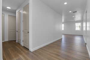 Hallway featuring dark wood-type flooring