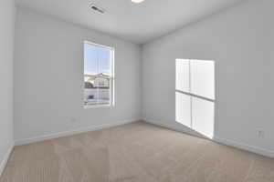 Spare room with light colored carpet