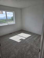 Spare room with baseboards and carpet floors