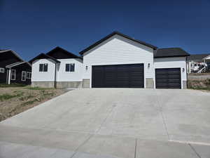 Modern farmhouse with an attached garage and driveway
