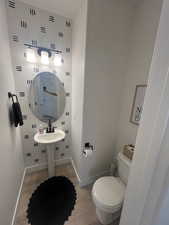 Bathroom with toilet and hardwood / wood-style floors