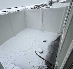 View of yard covered in snow