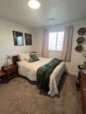 Bedroom featuring dark carpet