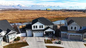 View of front of home featuring a water and mountain view and a garage