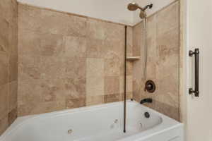 Bathroom featuring tiled shower / bath combo