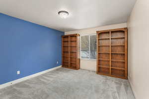 Unfurnished bedroom featuring light carpet