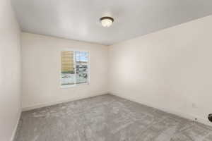 Unfurnished room with light colored carpet