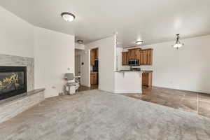 Unfurnished living room featuring dark carpet