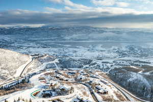 Snowy aerial view with a mountain view and a residential view