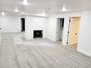 Great room  featuring light carpet and a large fireplace