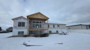 View of snow covered rear of property