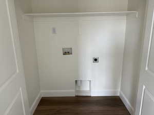 Washroom with baseboards, hookup for an electric dryer, dark wood-type flooring, and washer hookup