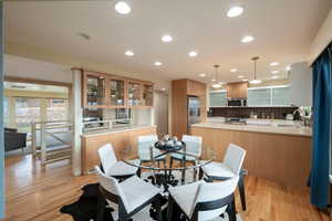 Dining area featuring sink and light wood-type flooring