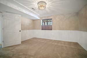 Unfurnished room with carpet floors and a textured ceiling