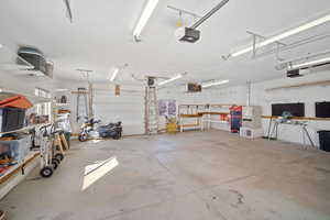 Garage with a garage door opener and a workshop area