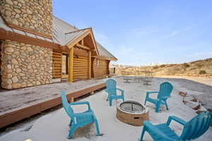 View of patio / terrace featuring a deck with mountain view and an outdoor fire pit