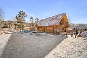 Rear view of property with a balcony and a mountain view