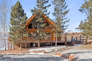 View of front of property with a wooden deck