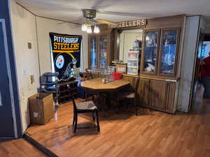 Dining space with hardwood / wood-style floors and ceiling fan