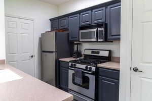 Kitchen with appliances with stainless steel finishes and sink