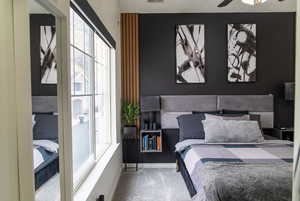 Bedroom featuring ceiling fan and carpet floors