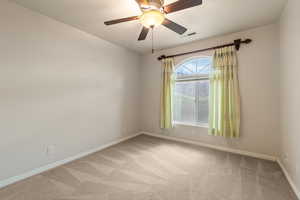 Unfurnished room featuring ceiling fan, a textured ceiling, and light colored carpet