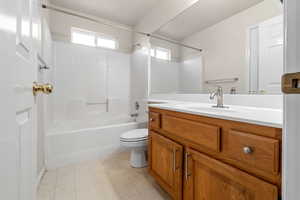 Full bathroom featuring vanity, tub / shower combination, tile patterned flooring, and toilet