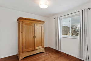 Unfurnished bedroom featuring hardwood / wood-style flooring