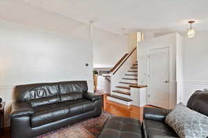 Living room featuring lofted ceiling and wood-type flooring