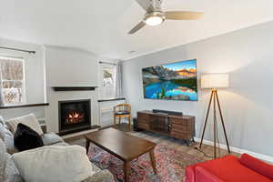 Living room featuring ceiling fan, light hardwood / wood-style flooring, and crown molding