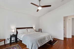 Bedroom featuring ceiling fan, lofted ceiling, and dark hardwood / wood-style flooring