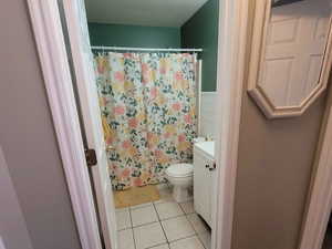 Bathroom with toilet, vanity, wood-type flooring, and walk in shower