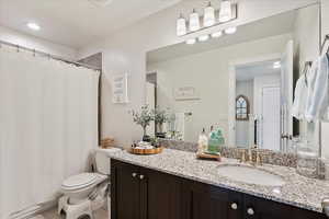 Bathroom featuring vanity, toilet, and tile patterned floors