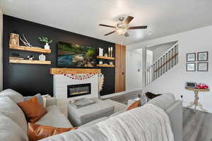 Living room featuring hardwood / wood-style floors and ceiling fan