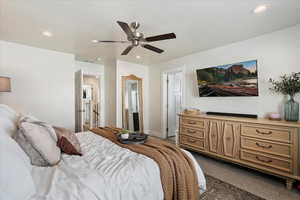 Carpeted bedroom with ceiling fan